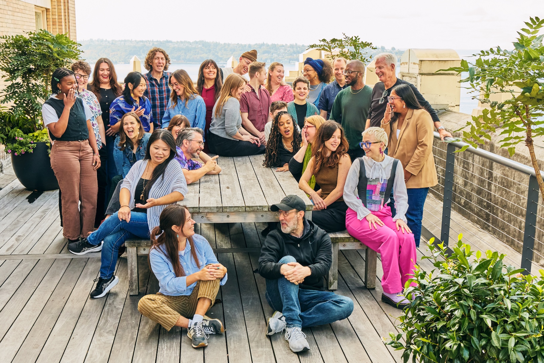 Group of 13 Pyramid staff, standing and sitting, having a variety of conversations