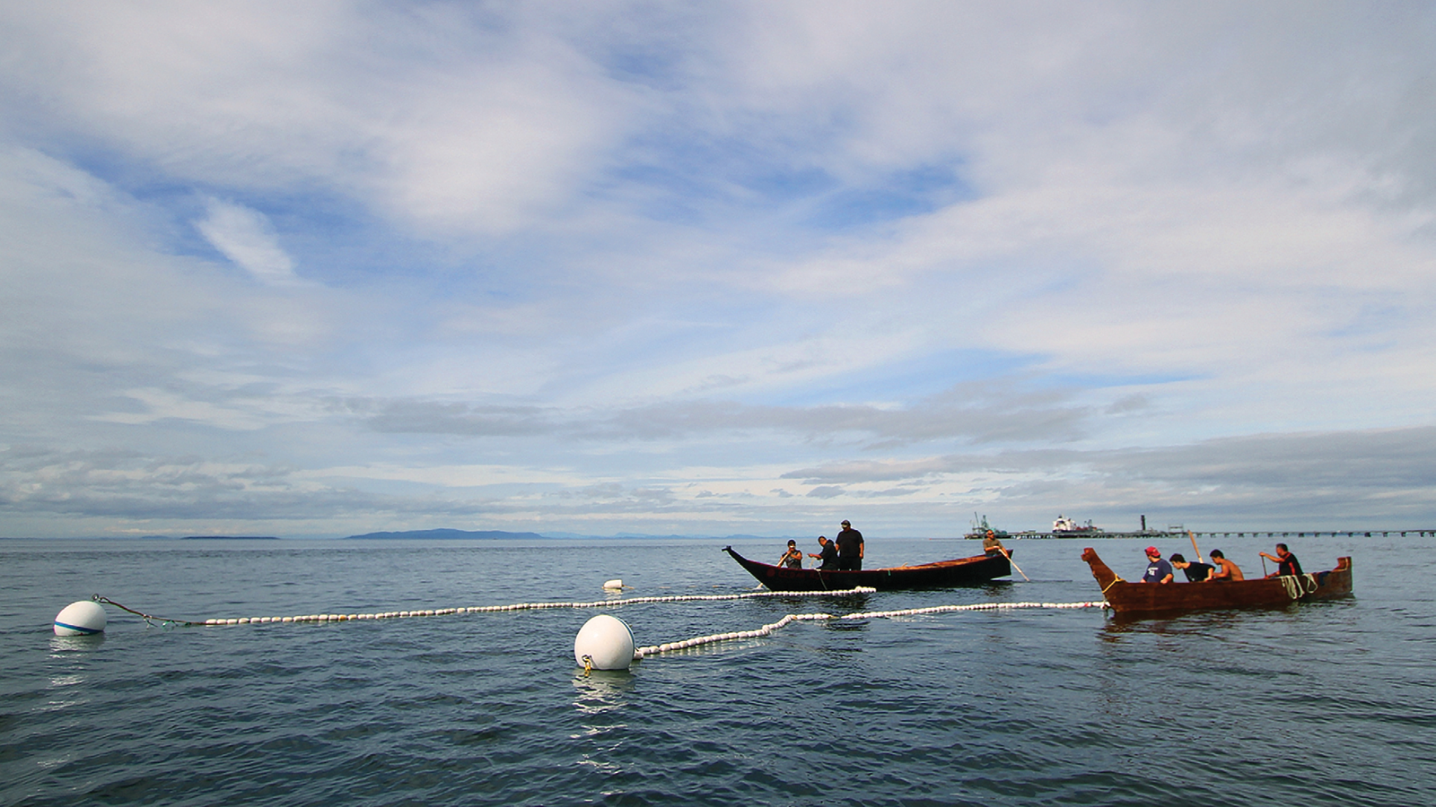 Lummi tribal members in canoes on the Puget Sound.